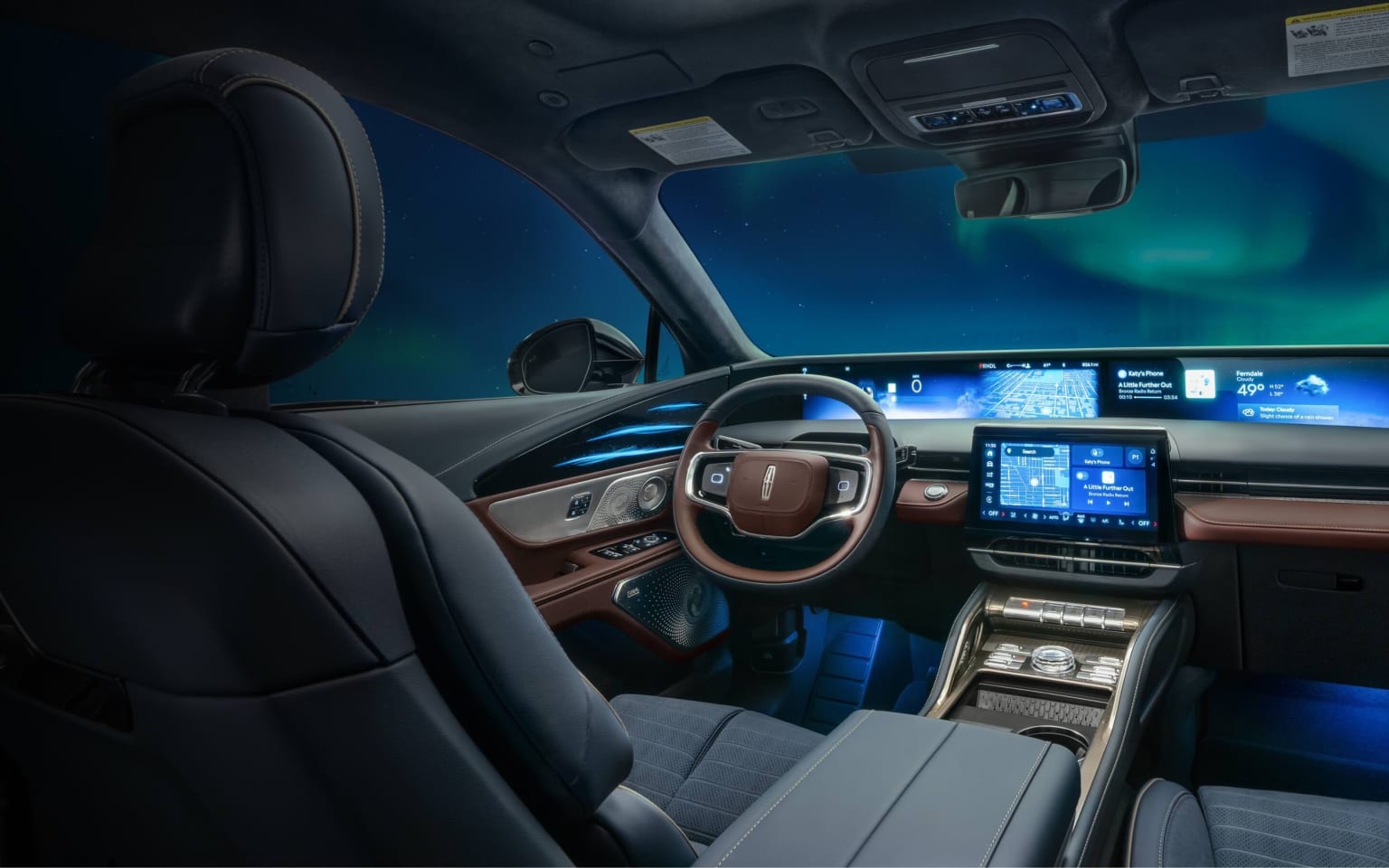 The interior of a futuristic-looking vehicle, with a sleek dashboard, a large display screen, and ambient blue lighting creating a high-tech atmosphere.