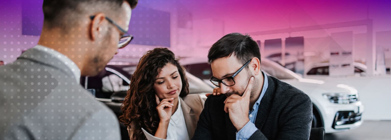 A group of people in a professional setting engaged in a serious discussion or meeting in an office or conference room with colorful, vibrant lighting.