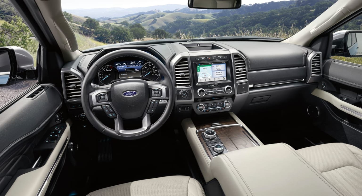 the interior of a ford f - 150 pickup truck with a view of the mountains in the back ground