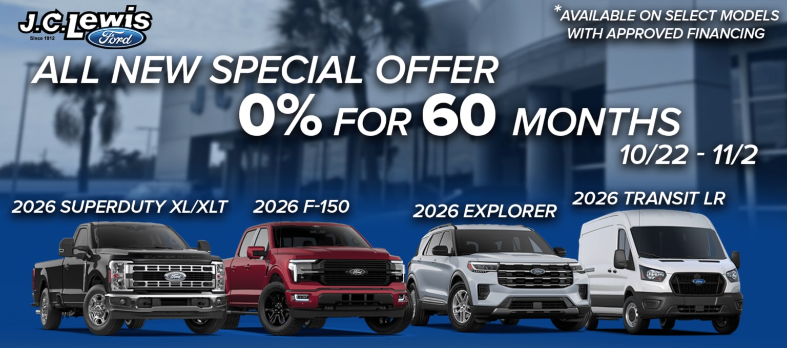 Four vehicles lined up in the foreground against a blurred background of a dealership building and palm trees.