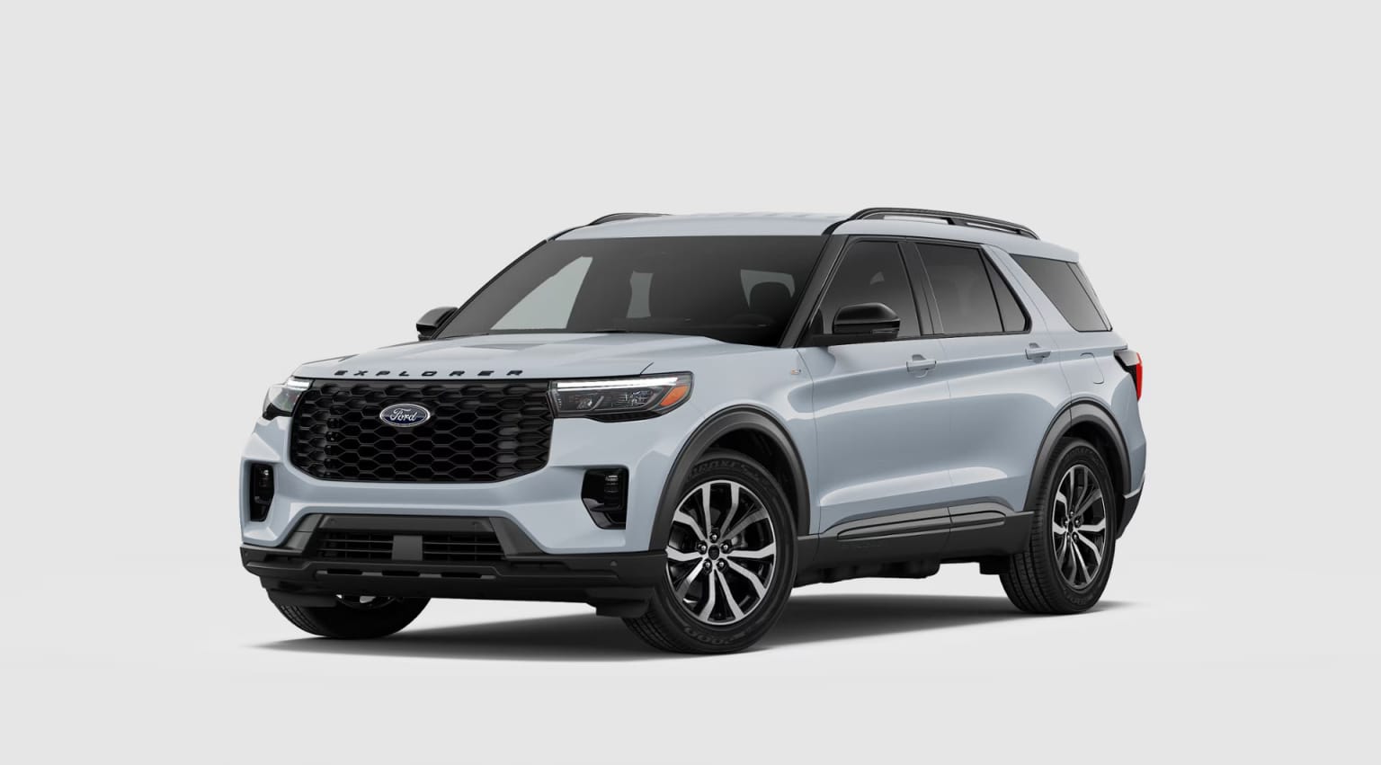A large, silver SUV with a bold, angular design and prominent grille stands in a plain, white background.