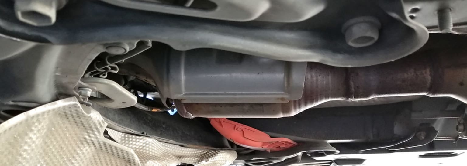 a close up of a car's exhaust pipe with a red object in the middle of the exhaust pipe