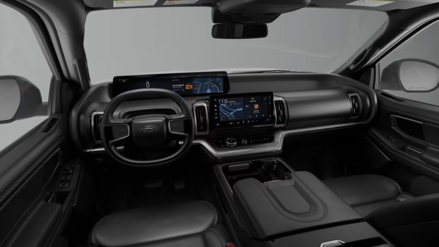 The image shows the interior of a vehicle with a dashboard featuring various controls and displays, including a large touchscreen display in the center. The steering wheel and other interior elements are visible in the foreground.