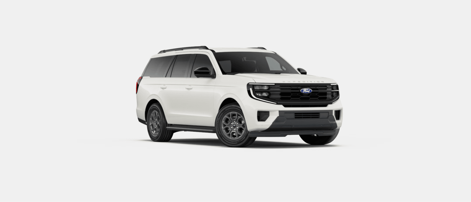 A white SUV is positioned in the center against a plain, light gray background.
