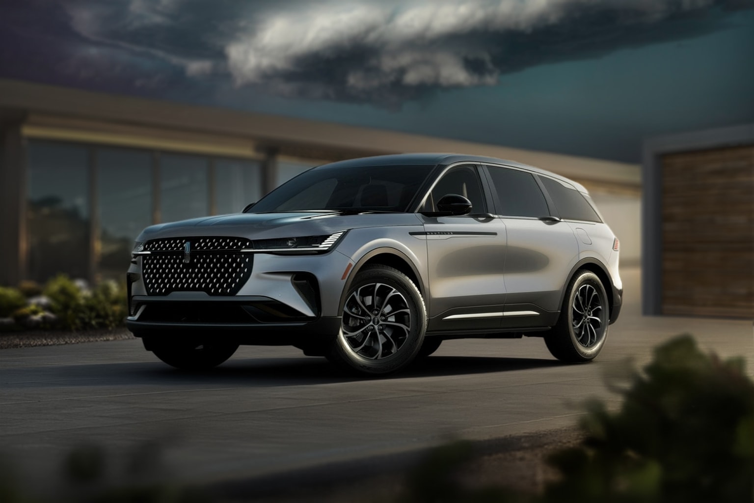 A sleek, silver SUV is parked in the foreground, with a dramatic stormy sky and ominous clouds looming in the background.