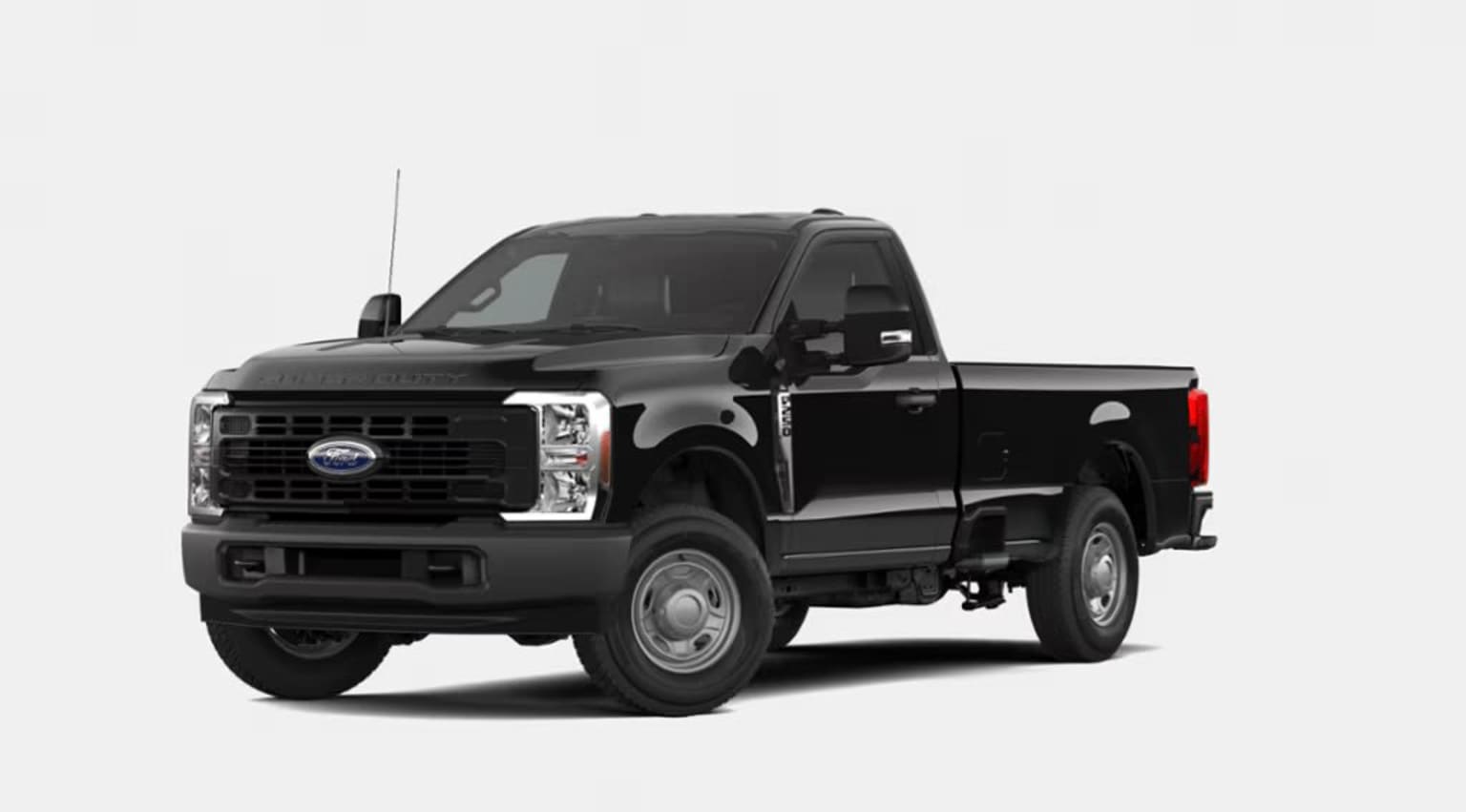 A black pickup truck with a flatbed in the foreground, set against a plain white background.