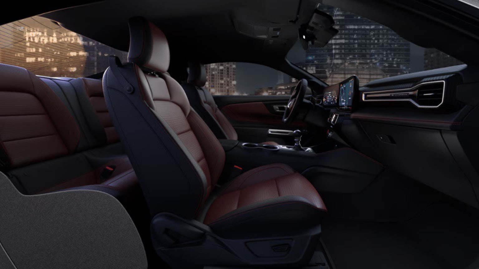 Interior of a modern, high-end vehicle at night with city skyline visible through windshield in background.
