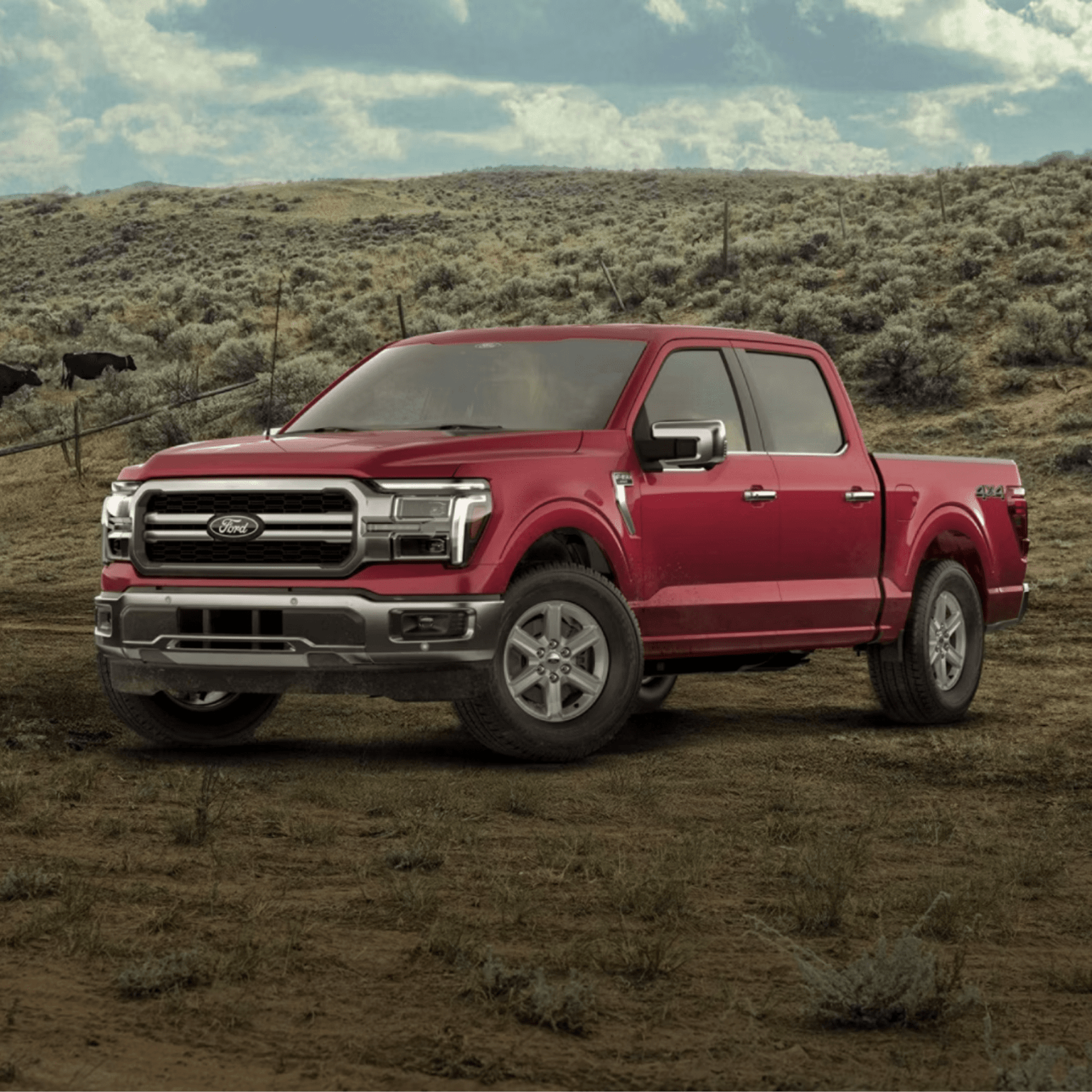 A red pickup truck on dirt ground with rolling hills and cloudy sky.