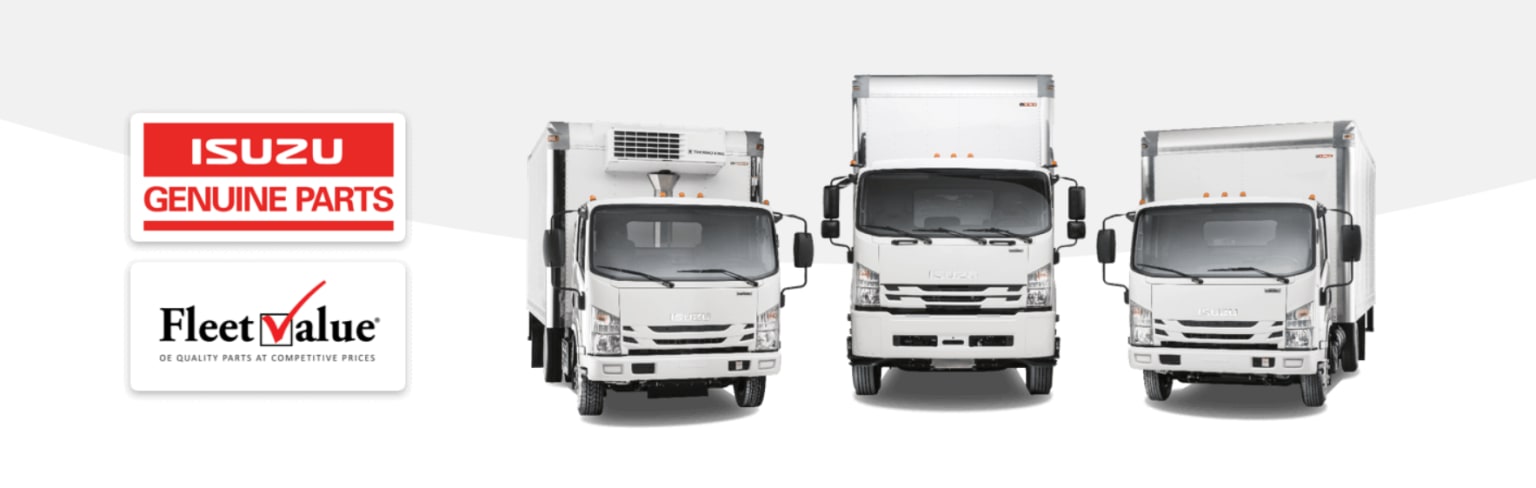 Several white commercial trucks parked in a row with a sign for "Parts" in the background.
