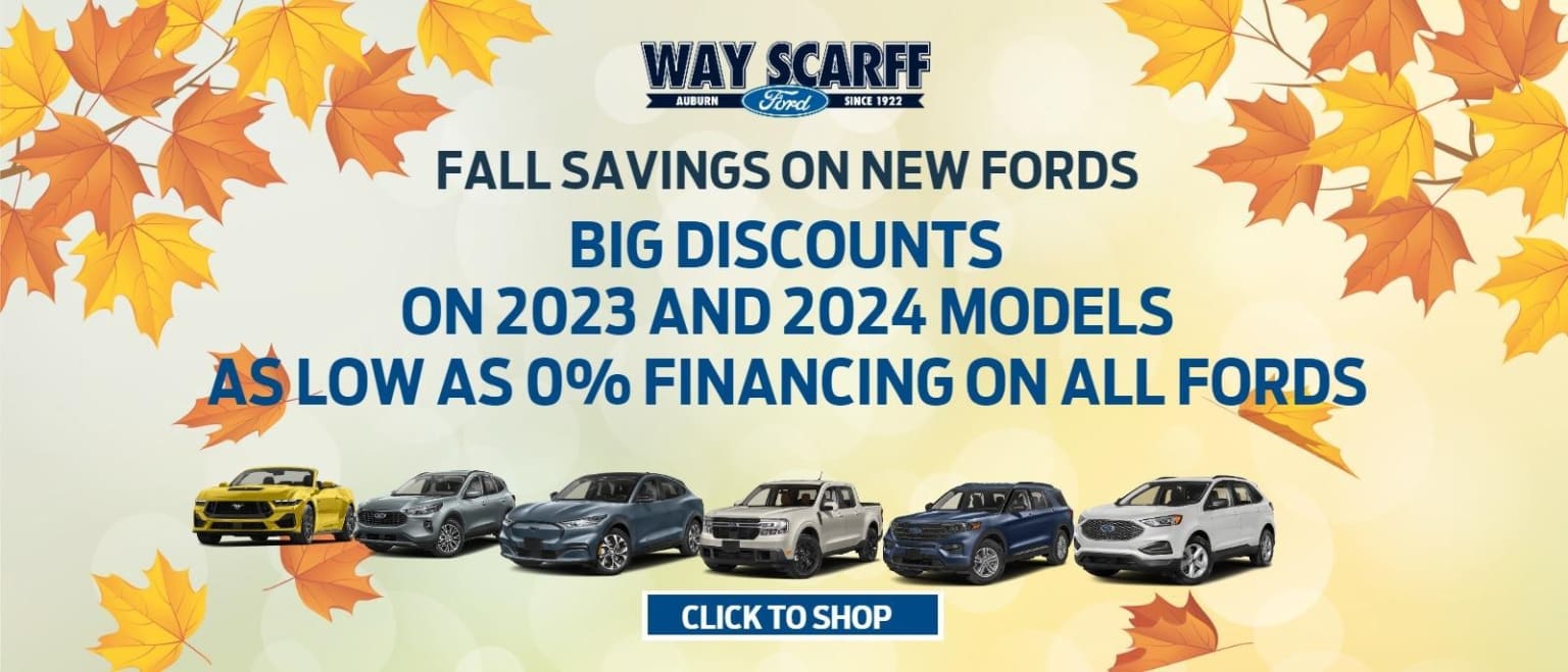 The image features a variety of vehicles, including SUVs and sedans, set against a background of vibrant autumn leaves. The text prominently displays "WAY SCARF" and advertises "Fall Savings on New Vehicles" with "Big Discounts on New Models" and "Special Financing Offers on All Vehicles".