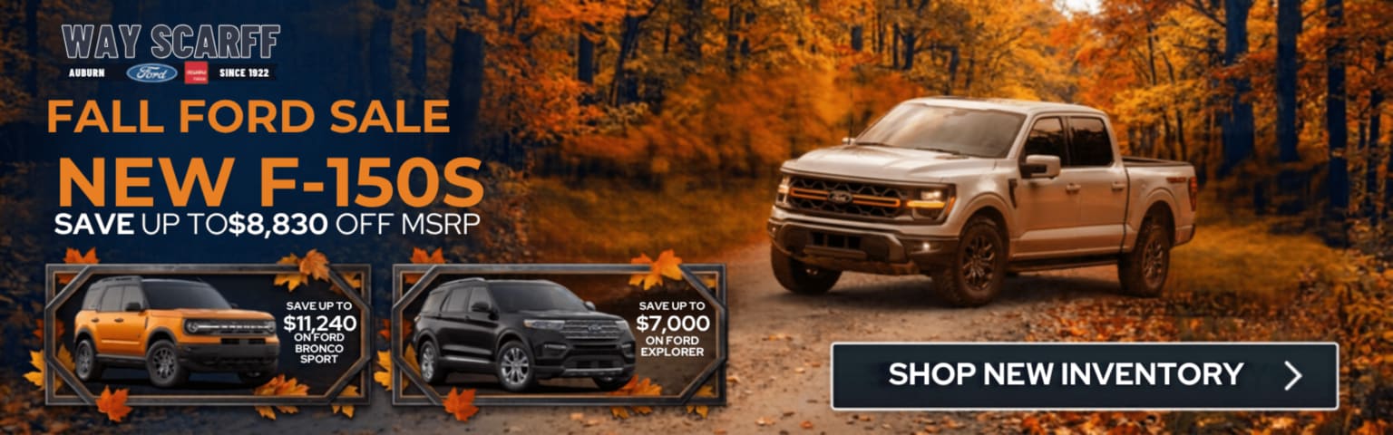 White pickup truck and other vehicles in front of autumn forest in advertisement.