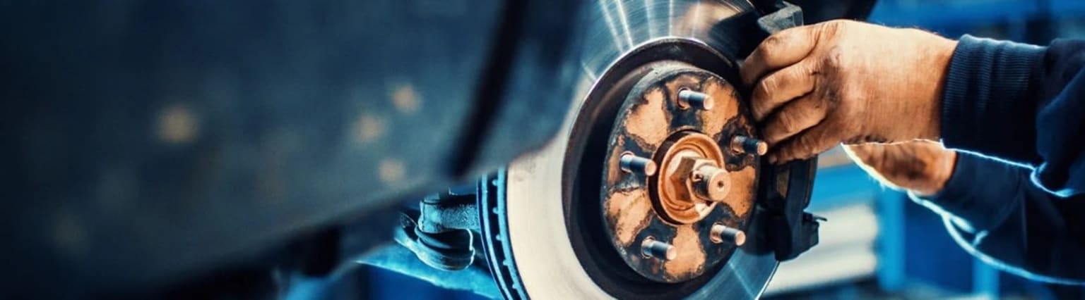 Close-up of a watch movement with intricate gears and components on a dark background.