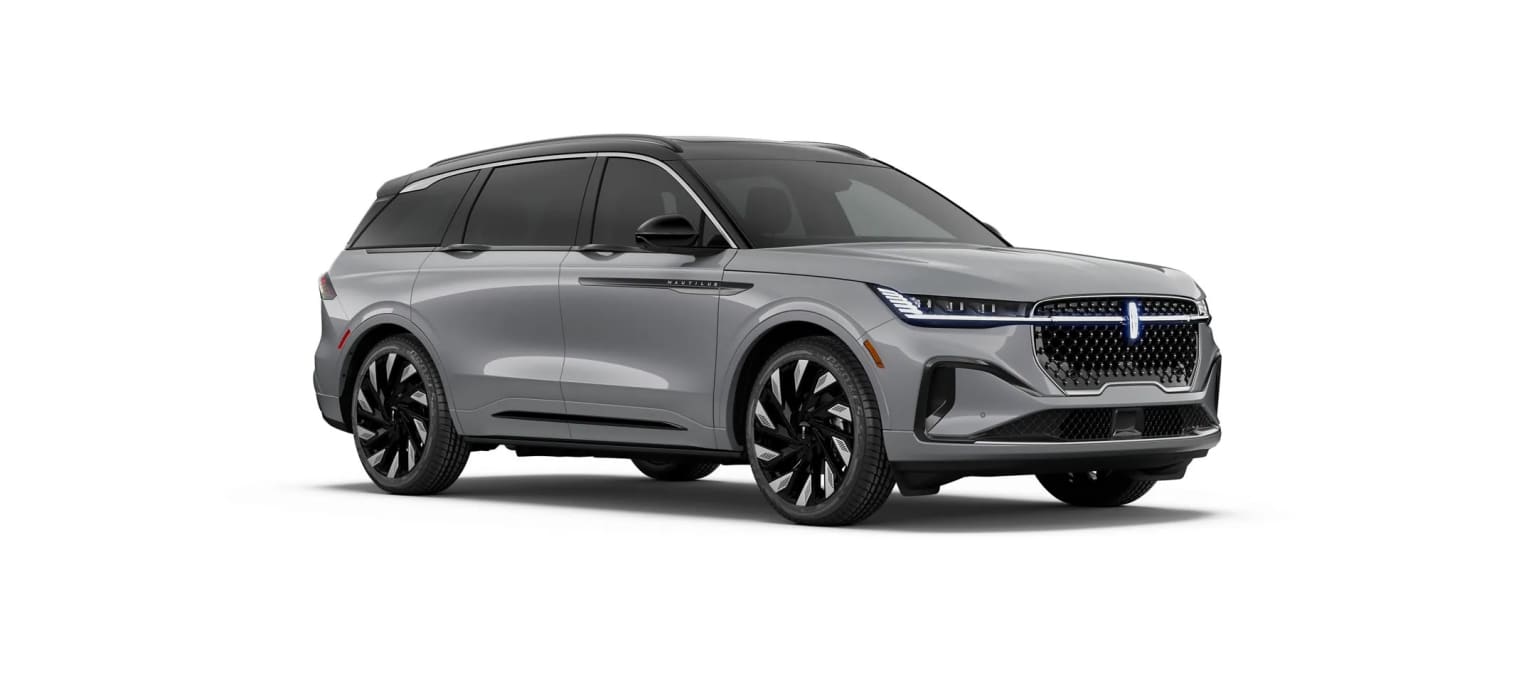 A large, sleek gray SUV with a bold front grille and distinctive headlights against a plain white background.