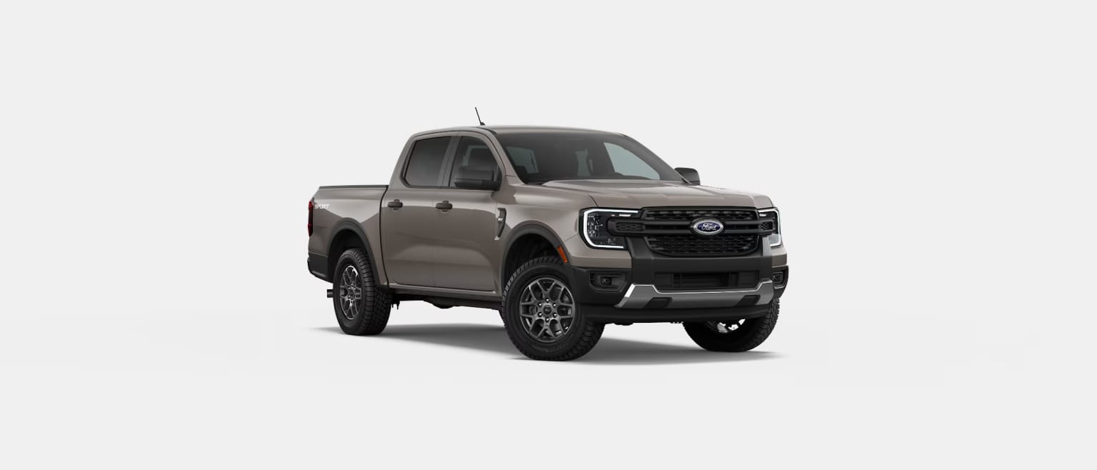 A rugged and imposing pickup truck with a bold, aggressive design stands prominently in the frame, its matte gray exterior and large off-road tires suggesting a vehicle built for tough terrain and demanding tasks.