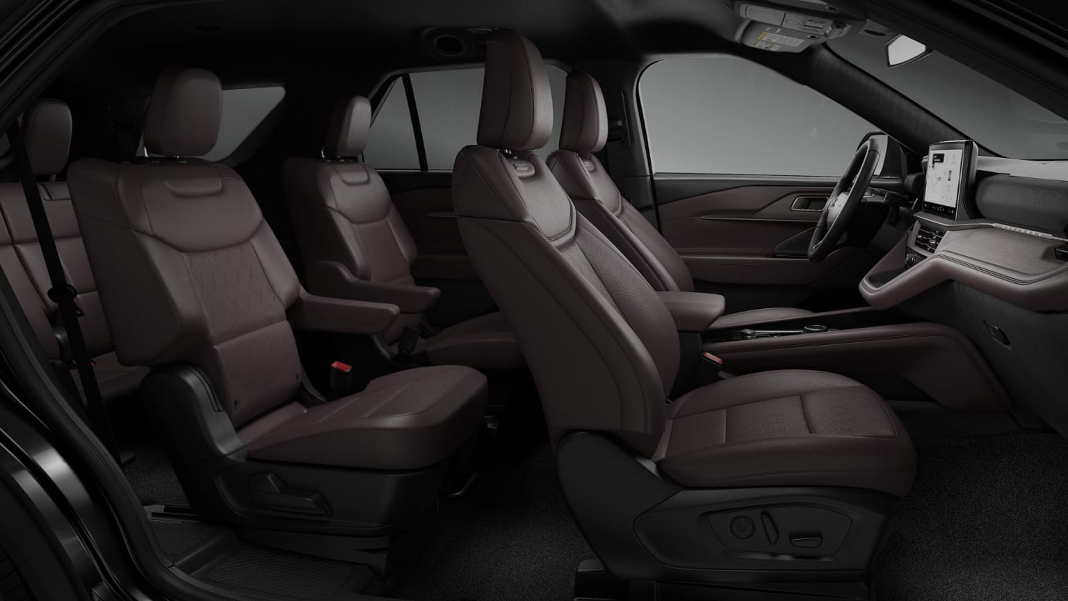 The image shows the interior of a vehicle, with multiple rows of comfortable-looking leather seats in a dark, monochromatic color scheme. The background appears to be the dashboard and other interior features, creating a sleek and modern aesthetic.