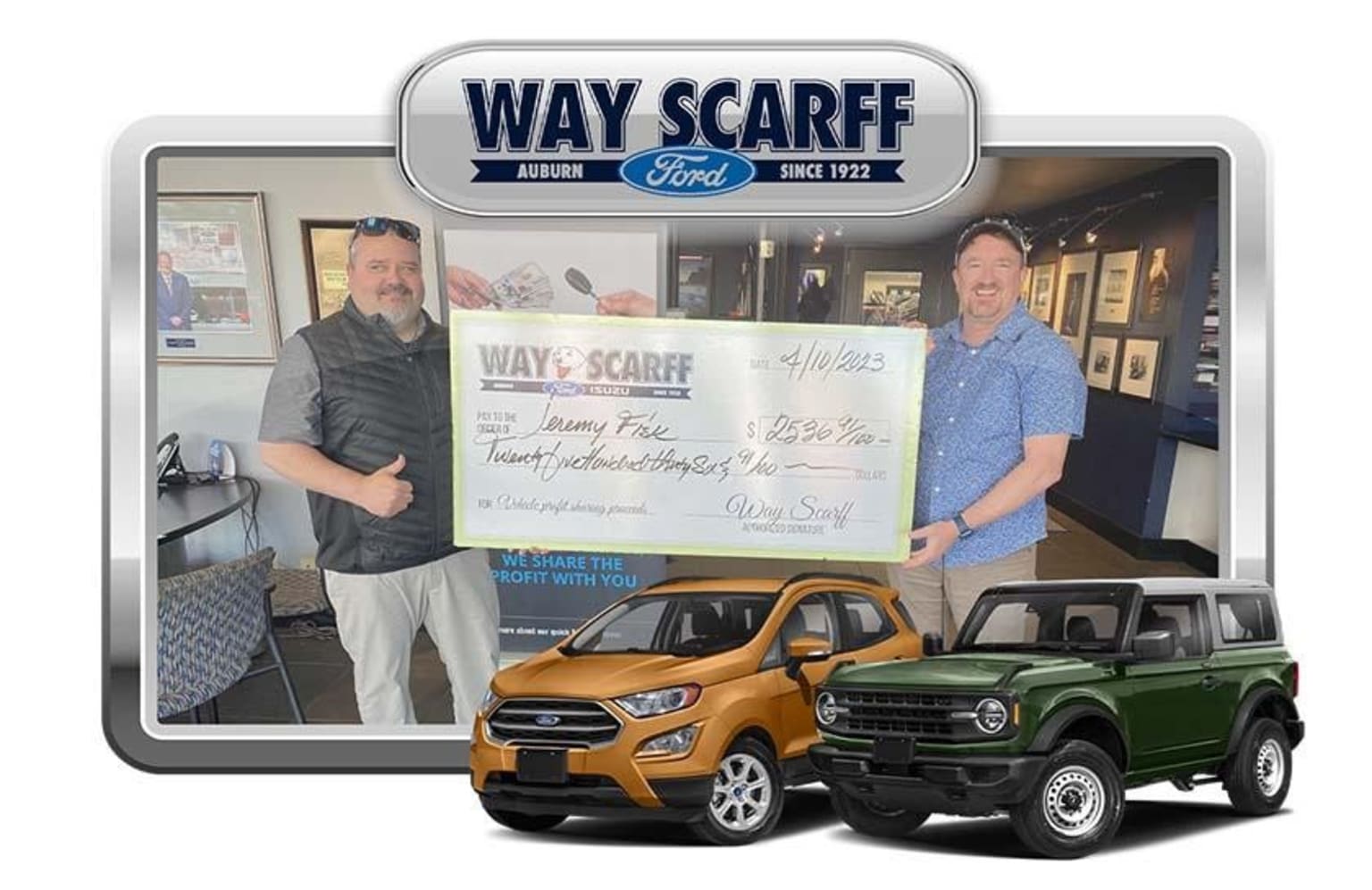 Two men standing in front of a dealership holding a large check, with two vehicles in the background - an orange SUV and a green off-road vehicle.