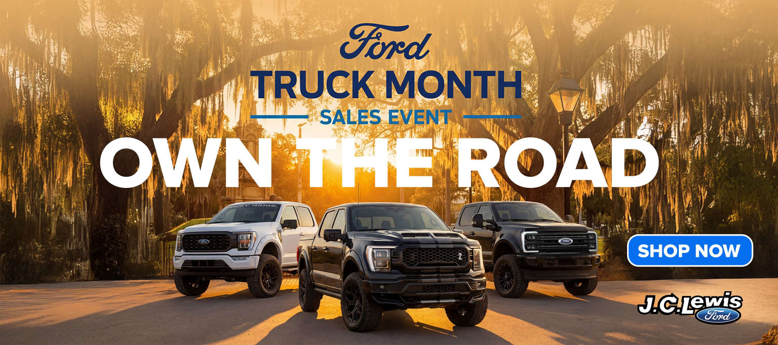 "Truck Month sales event advertisement showcasing various truck models in the foreground against a backdrop of a scenic, sun-dappled forest."