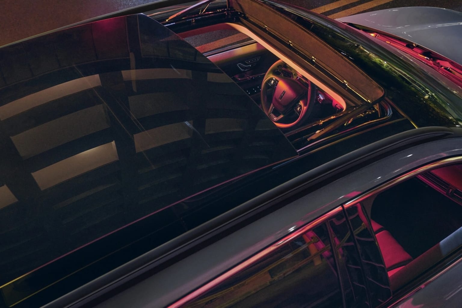 Car interior with red and orange lighting for automotive dealership.