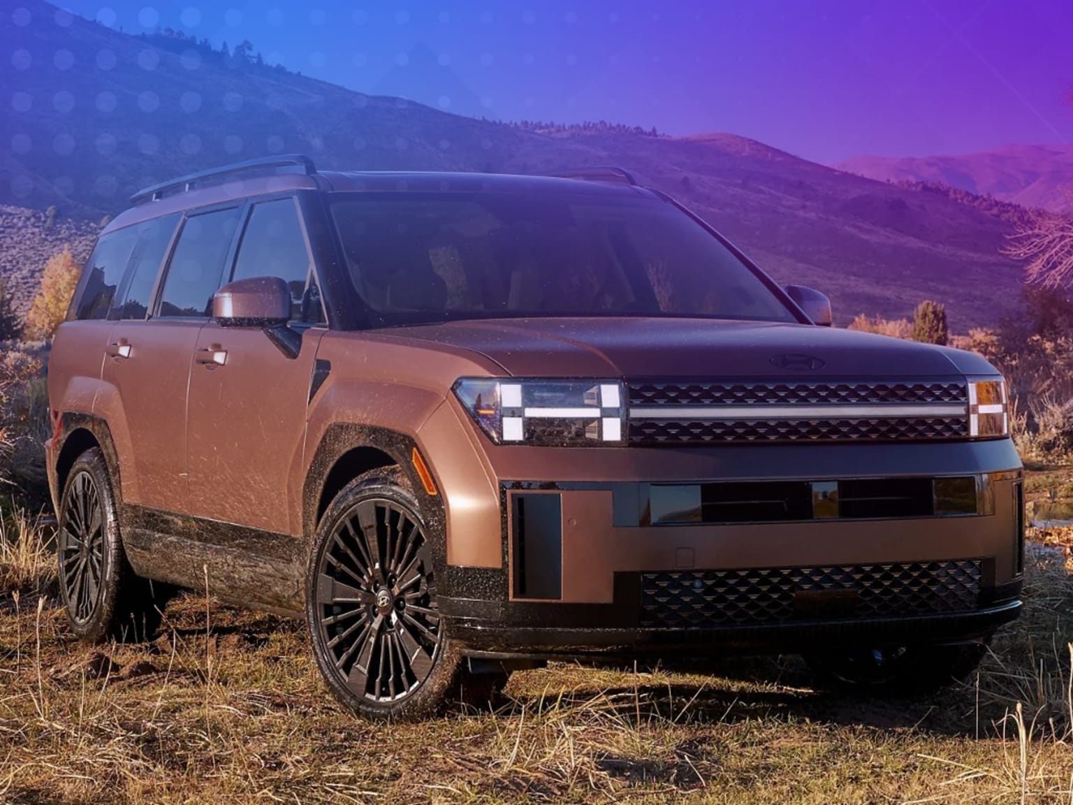 A large, rugged-looking SUV in a grassy field, with a mountainous landscape and vibrant purple and blue sky in the background.