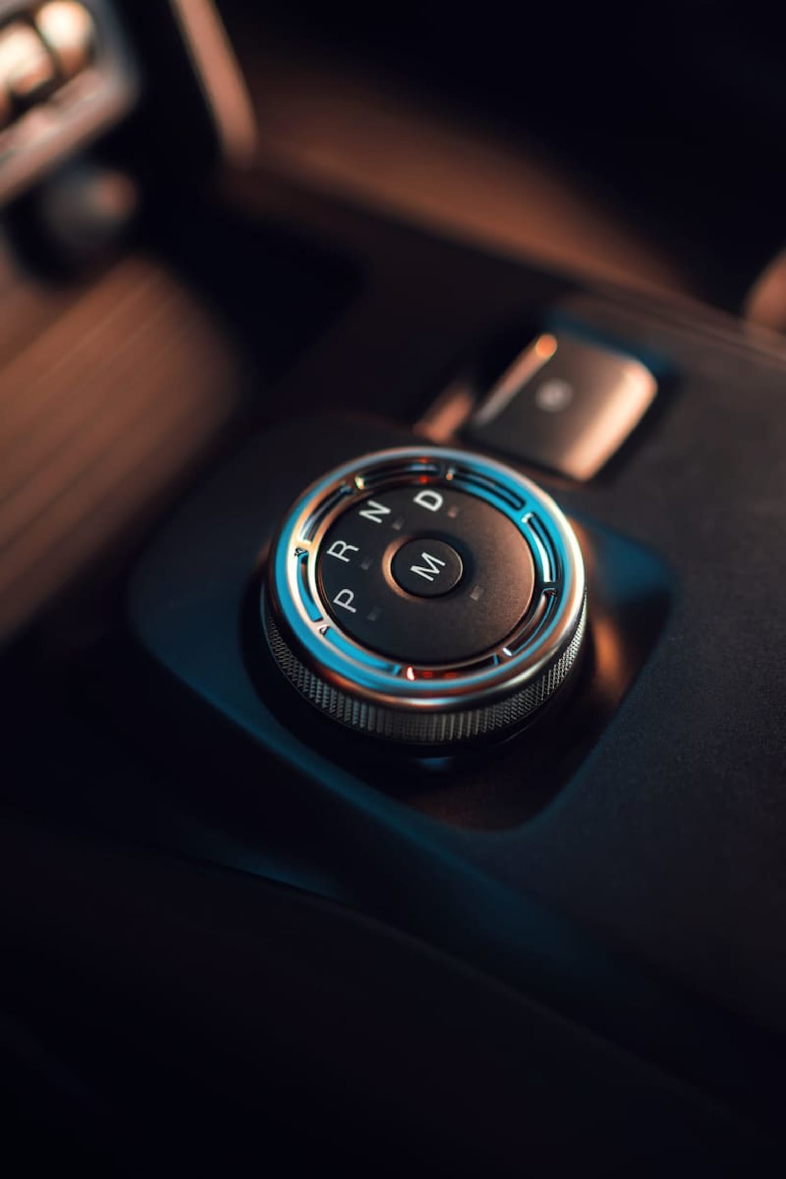 a close up of a button on a car's steering wheel knobs and a steering wheel cover