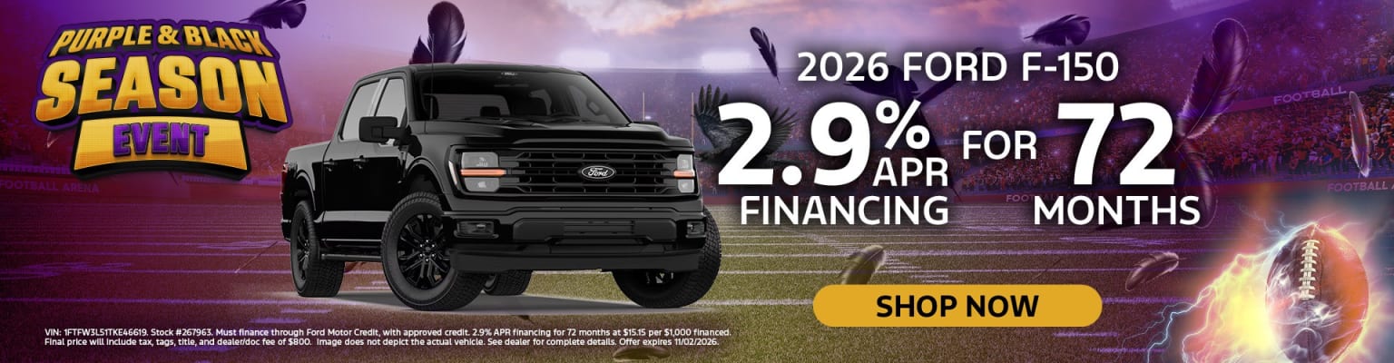 A black pickup truck parked in front of a football stadium with a glowing football and promotional text.