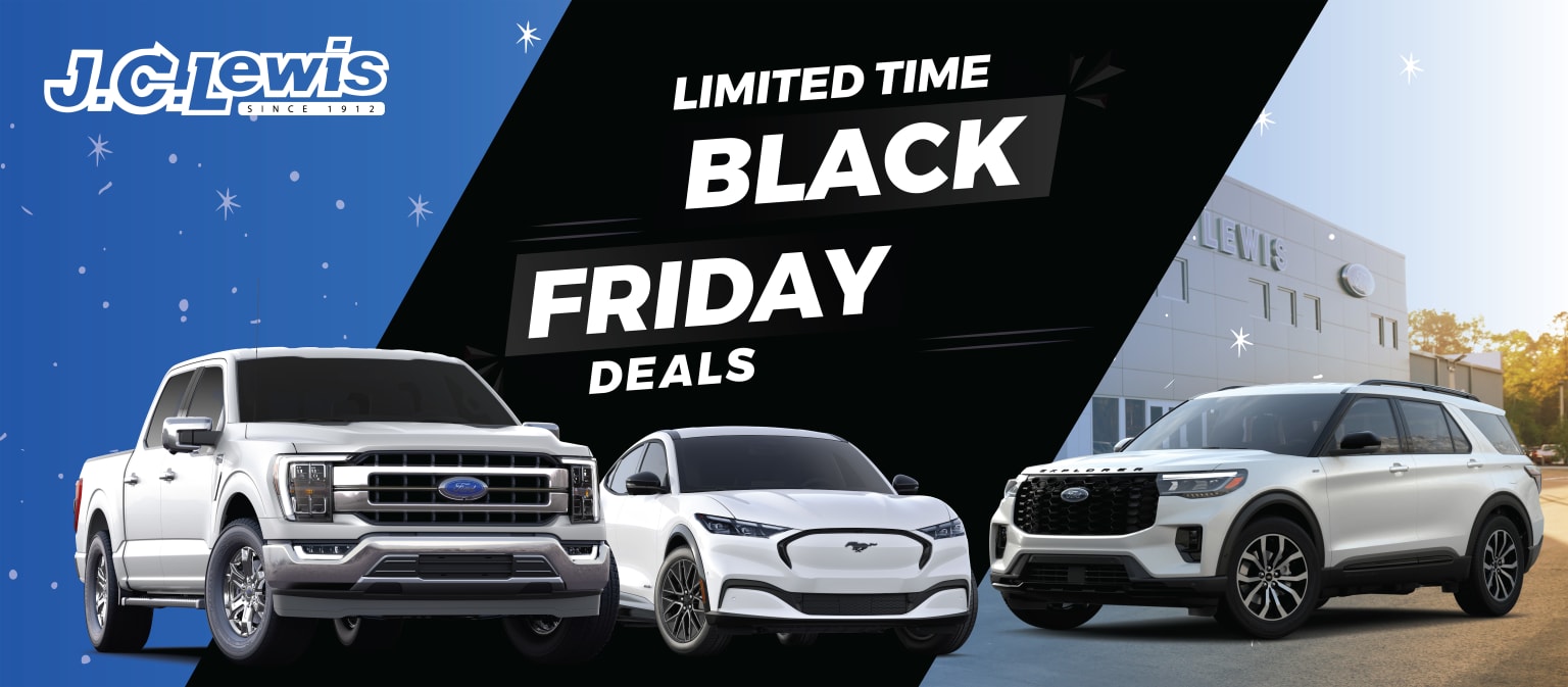 A selection of vehicles, including trucks and SUVs, in front of a sign promoting limited time Black Friday deals.