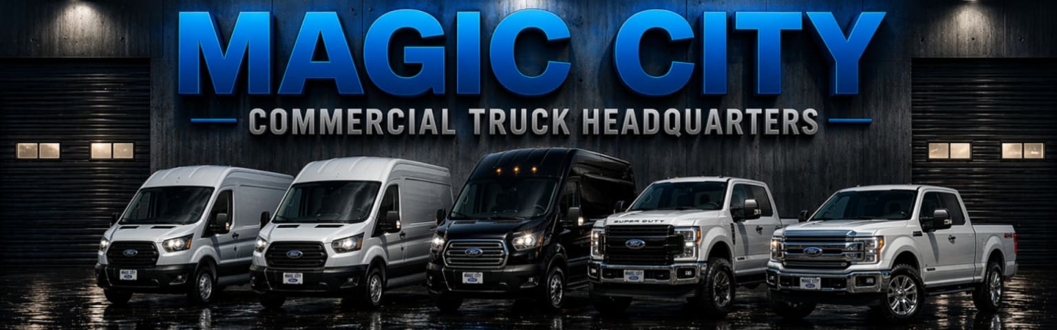 Storefront of a commercial truck dealership with a variety of commercial trucks and vans in the foreground on a dark, rainy day.