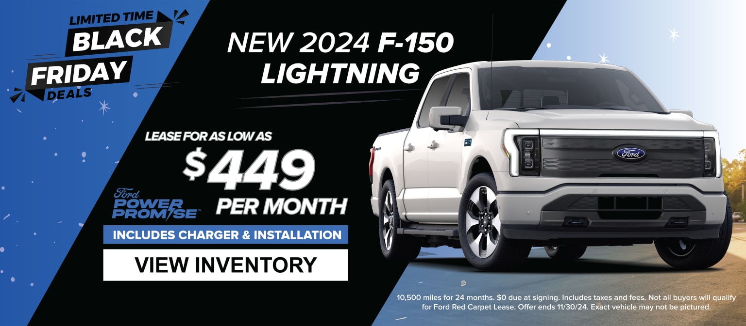 A white electric pickup truck on a Black Friday-themed background.