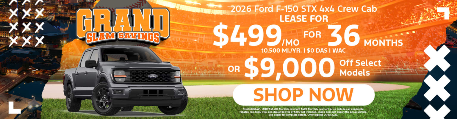 The image displays a pickup truck in the foreground, with a large advertisement for a lease offer displayed in the background.