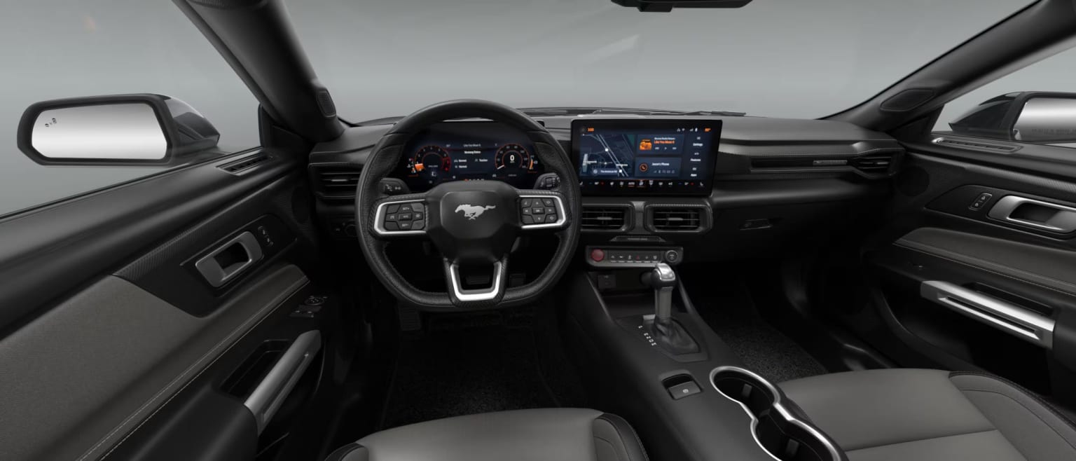 The image shows the interior of a modern vehicle, with a sleek and high-tech dashboard featuring various controls and displays.