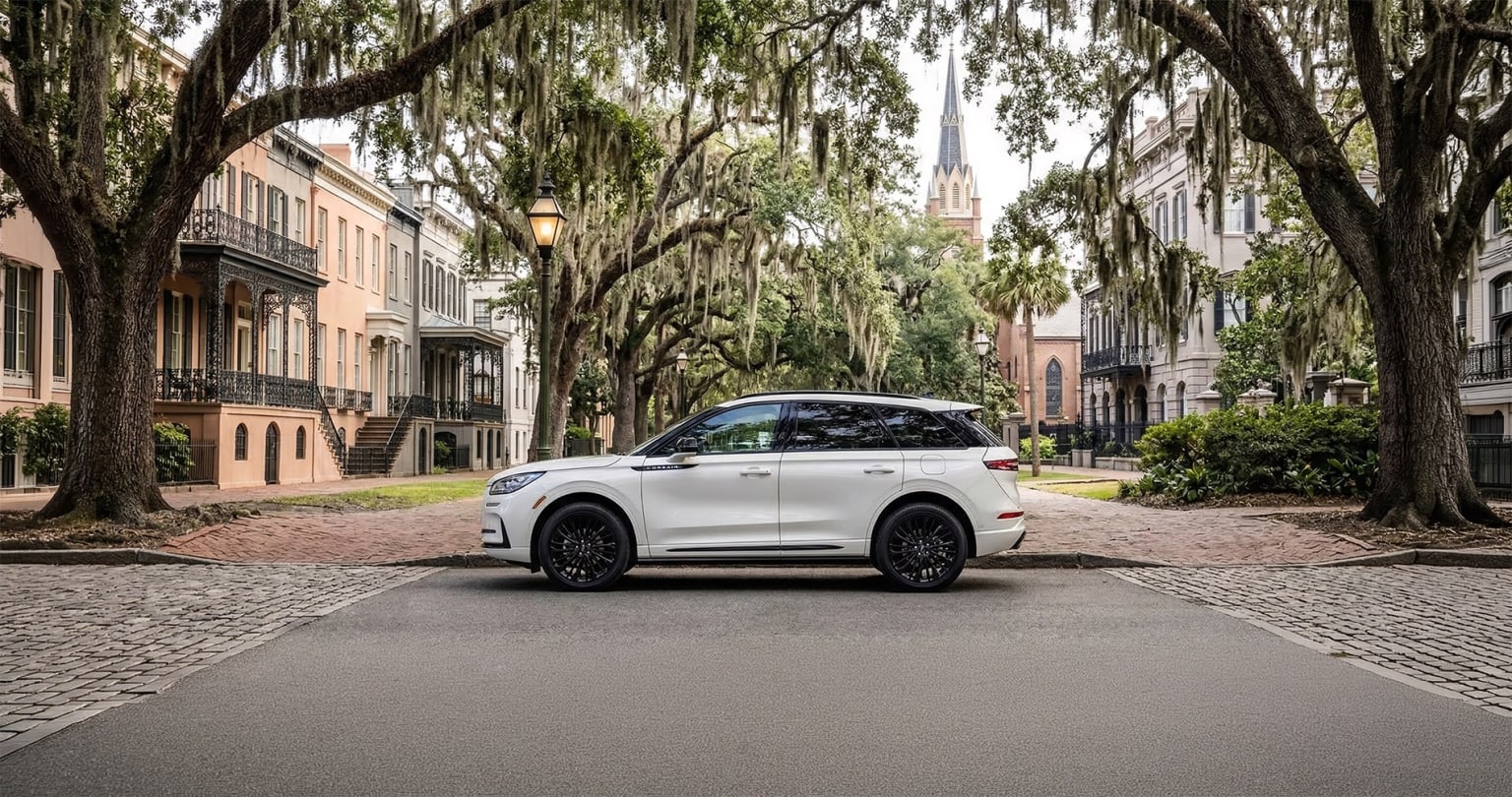 Lincoln Corsair luxury SUV parked on a tree-lined historic street with Southern architecture in Savannah