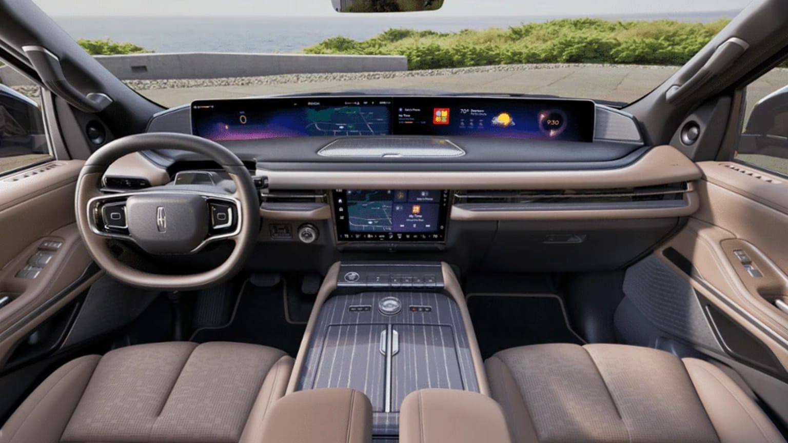 The image portrays the interior of a contemporary vehicle, featuring a sizable digital display panel on the center console and a steering wheel in the foreground. The background indicates an outdoor location, with greenery and a picturesque view seen through the windshield.