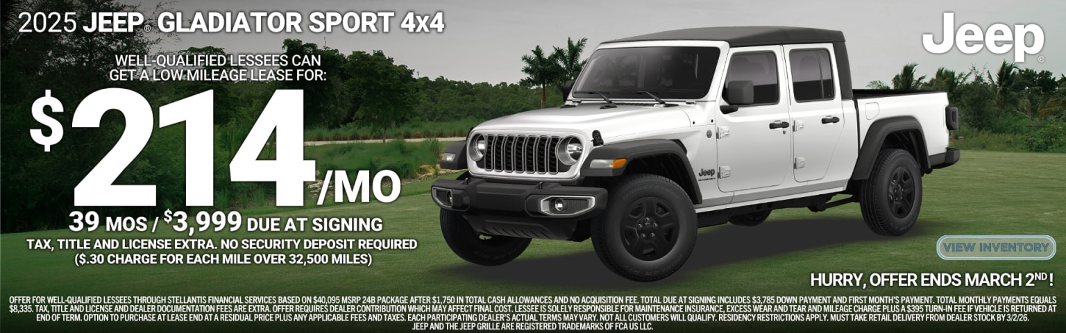 The image shows a white 4x4 vehicle with a prominent branding on the side, set against a backdrop of a forested area.