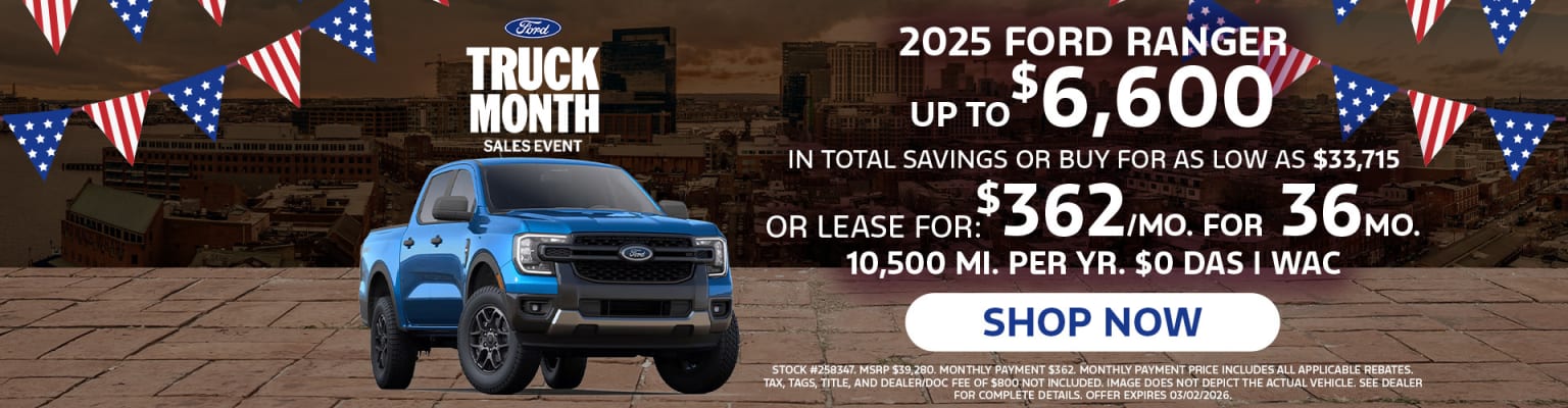 The image features a large blue truck in the foreground, with a promotional advertisement for a "Truck Month Sales Event" displayed in the background, highlighting the 2025 Ranger model and its associated pricing and leasing options.