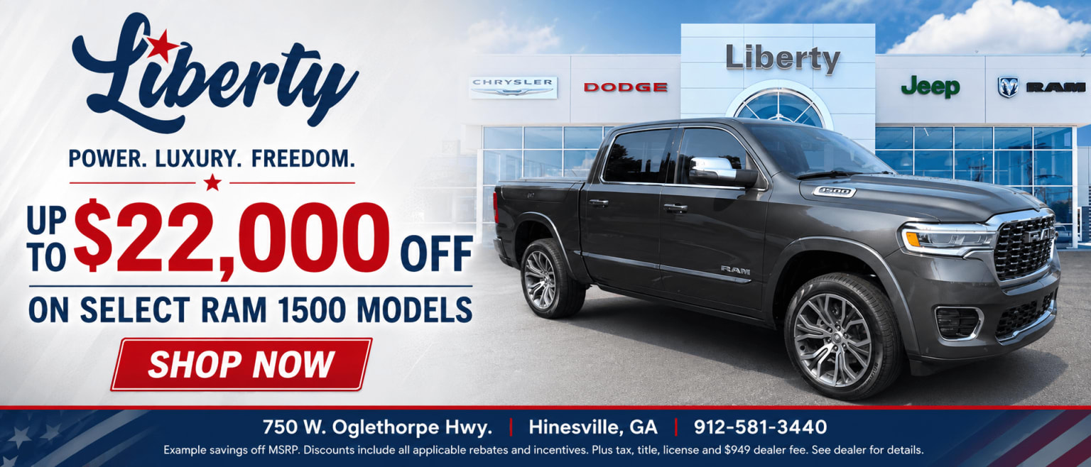 A dark gray truck is parked in front of a Liberty dealership with various car brand logos. The left side advertises discounts on select models.