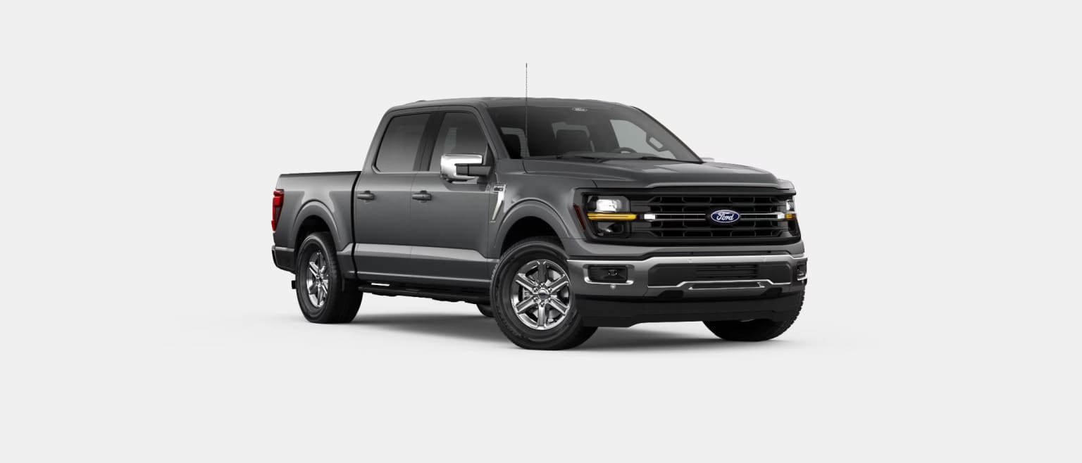 A dark gray pickup truck with a rugged, off-road appearance stands prominently in the center of the image against a plain white background.