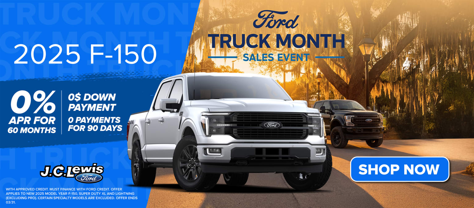 Image of a truck displayed in the foreground with a promotional banner for a "Truck Month Sales Event" in the background, set against a vibrant sunset landscape.