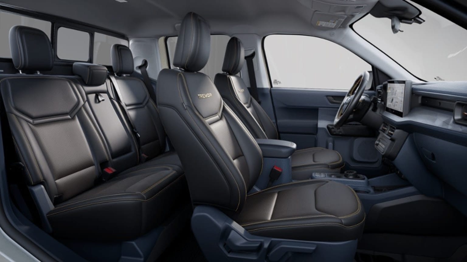 Interior of a vehicle with multiple rows of black leather seats and various controls and features visible in the background.