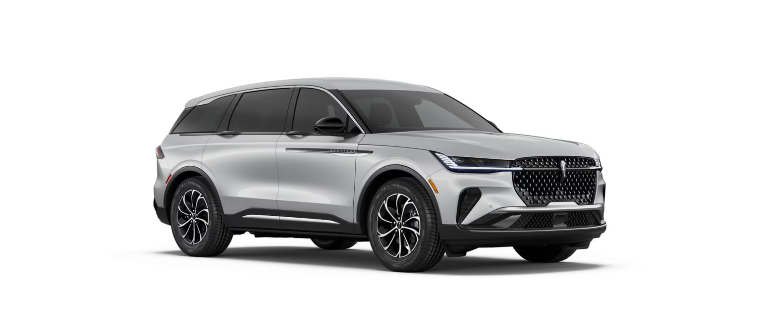 A silver SUV with a distinctive grille design, parked against a plain white background.
