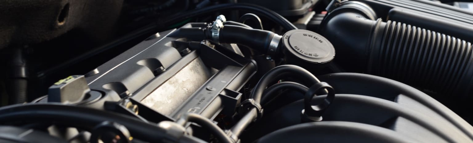 a close up of a car's engine with a steering wheel in the center of the engine compartment