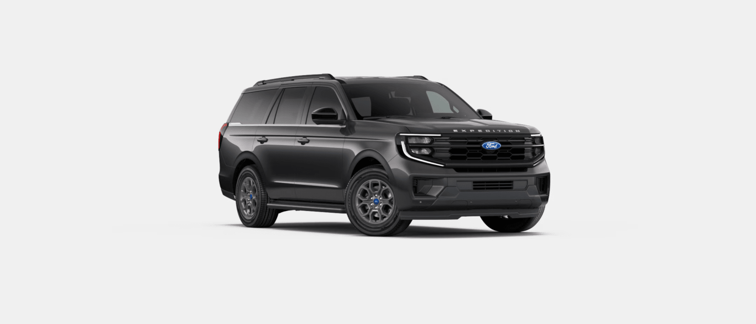 An angled view of a dark gray SUV against a plain white background.