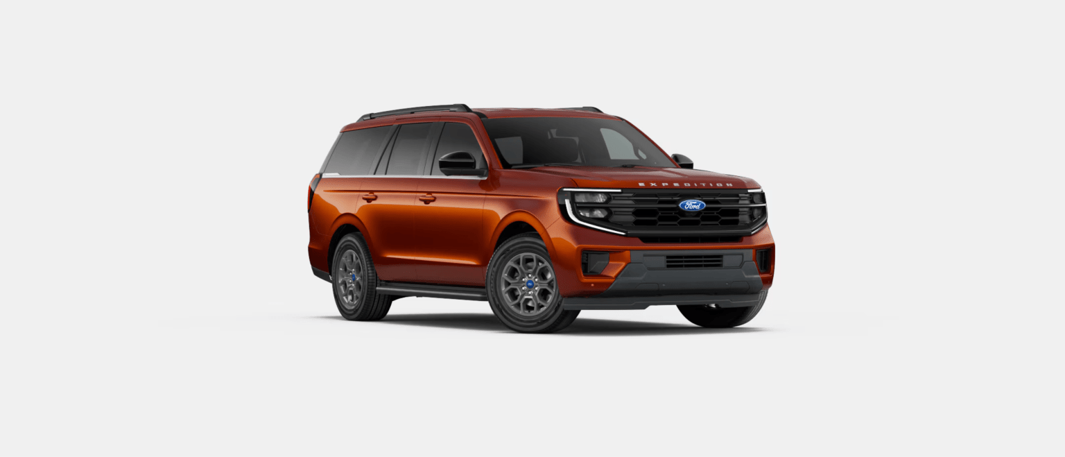 An SUV in metallic orange color is parked on a plain white background.