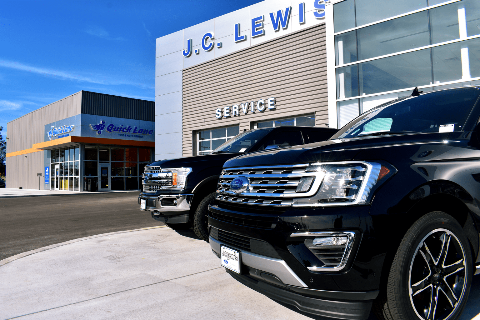 SUV parked in front of a building with front end facing the camera.