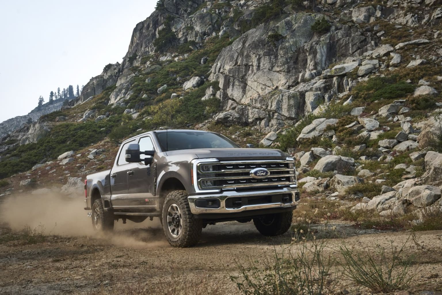 Off-road pickup truck navigating a rocky terrain.