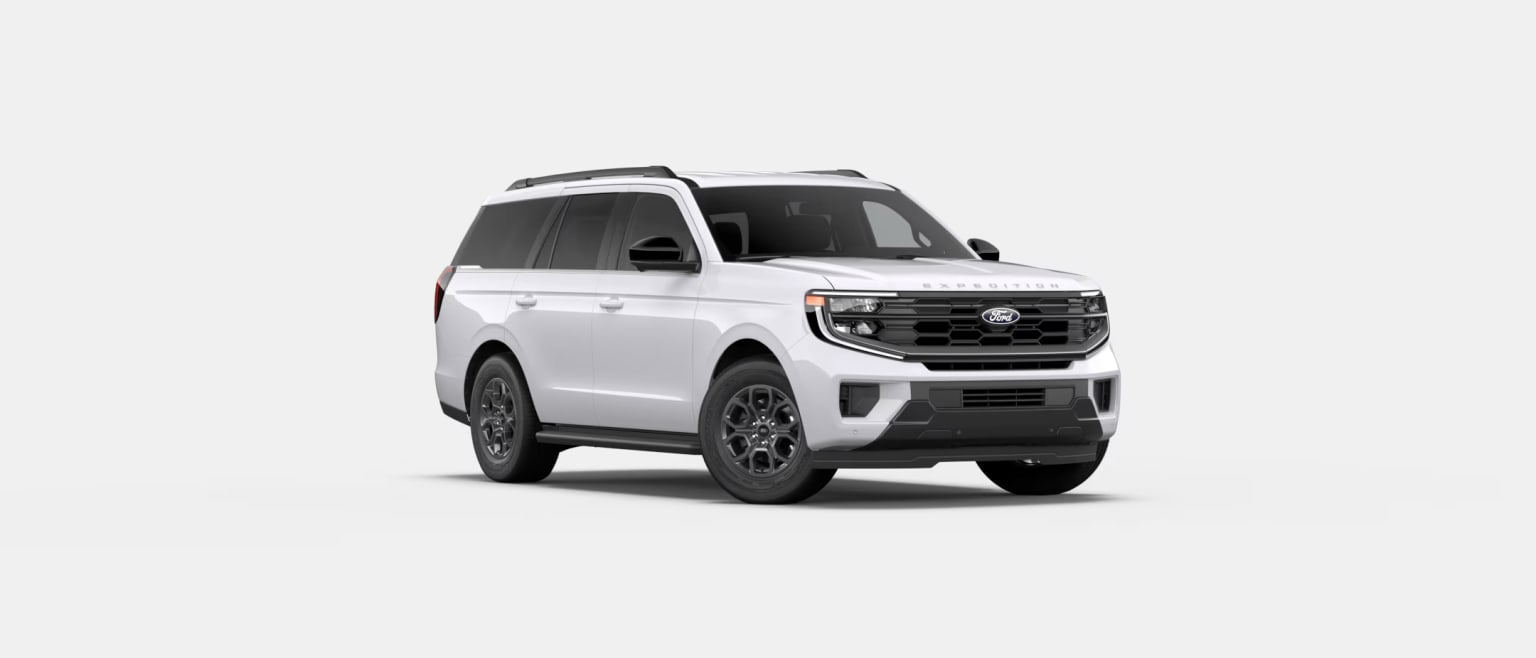 A white SUV with a rugged, off-road design stands prominently in the frame, its bold front grille and sleek lines suggesting a powerful and capable vehicle.