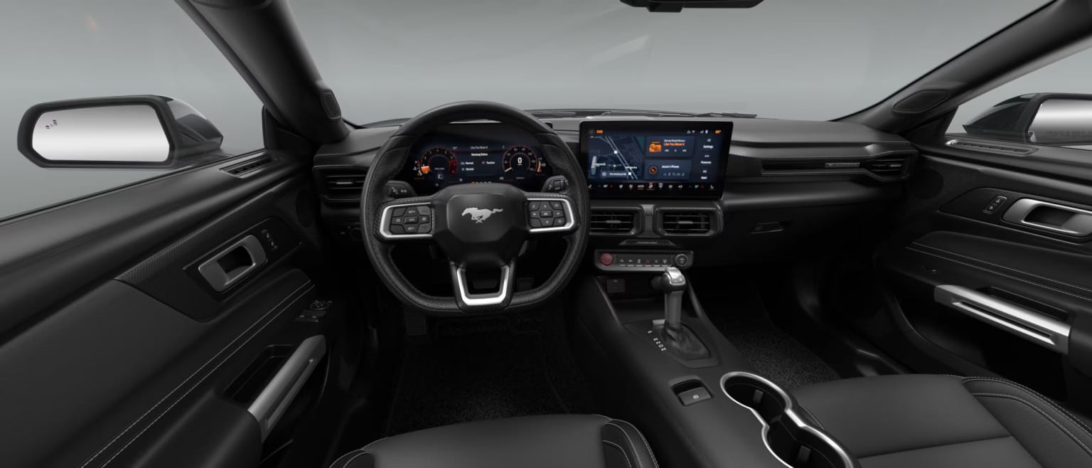 Interior of a modern vehicle with a sleek and high-tech dashboard featuring a large touchscreen display, various controls, and a steering wheel with integrated buttons.