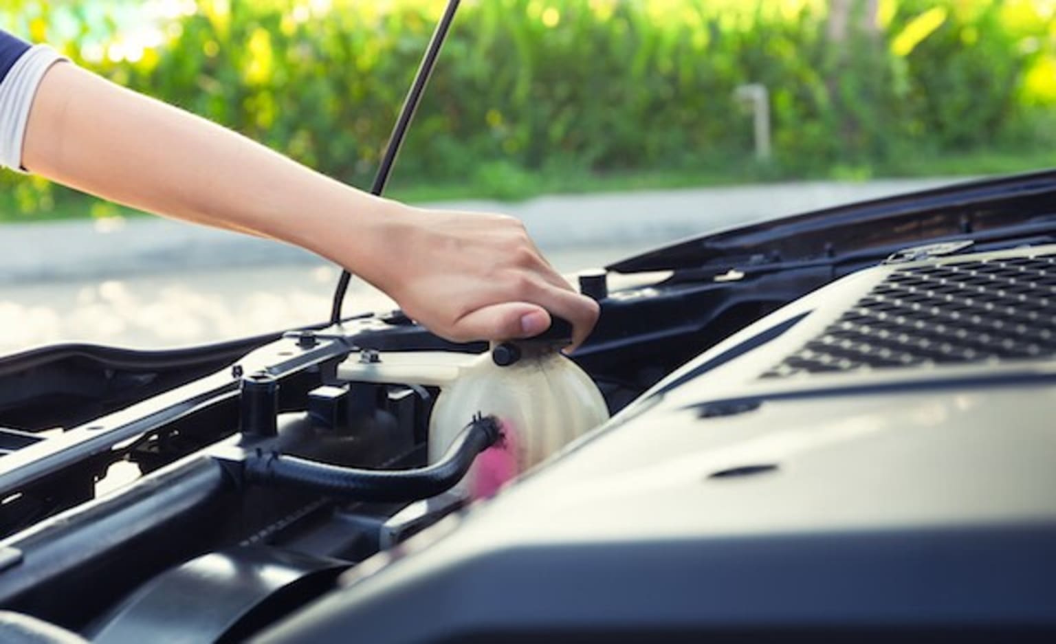 a person is changing the oil on a car's engine with a wrench and a wrench in their hand