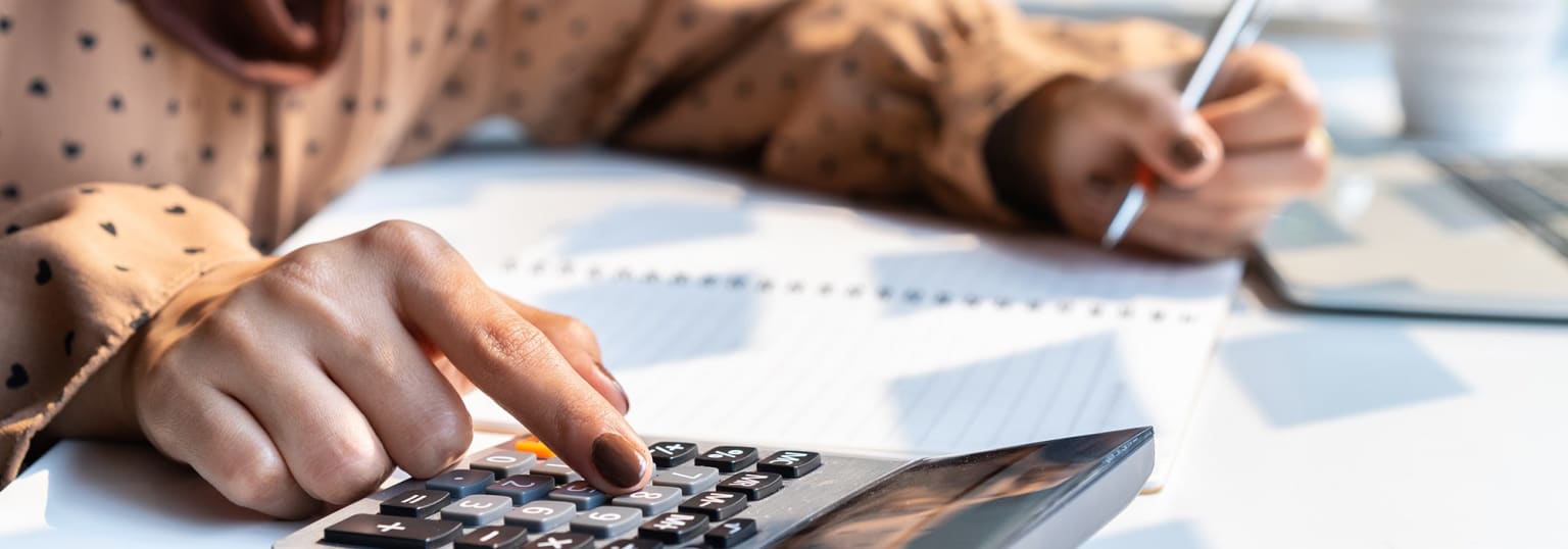 Woman using calculator