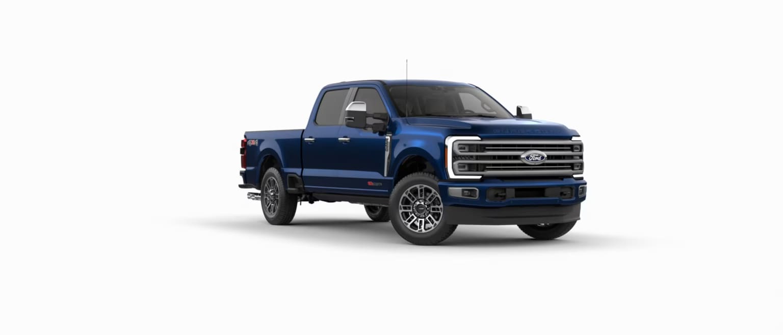 Blue pickup truck in foreground against white background.