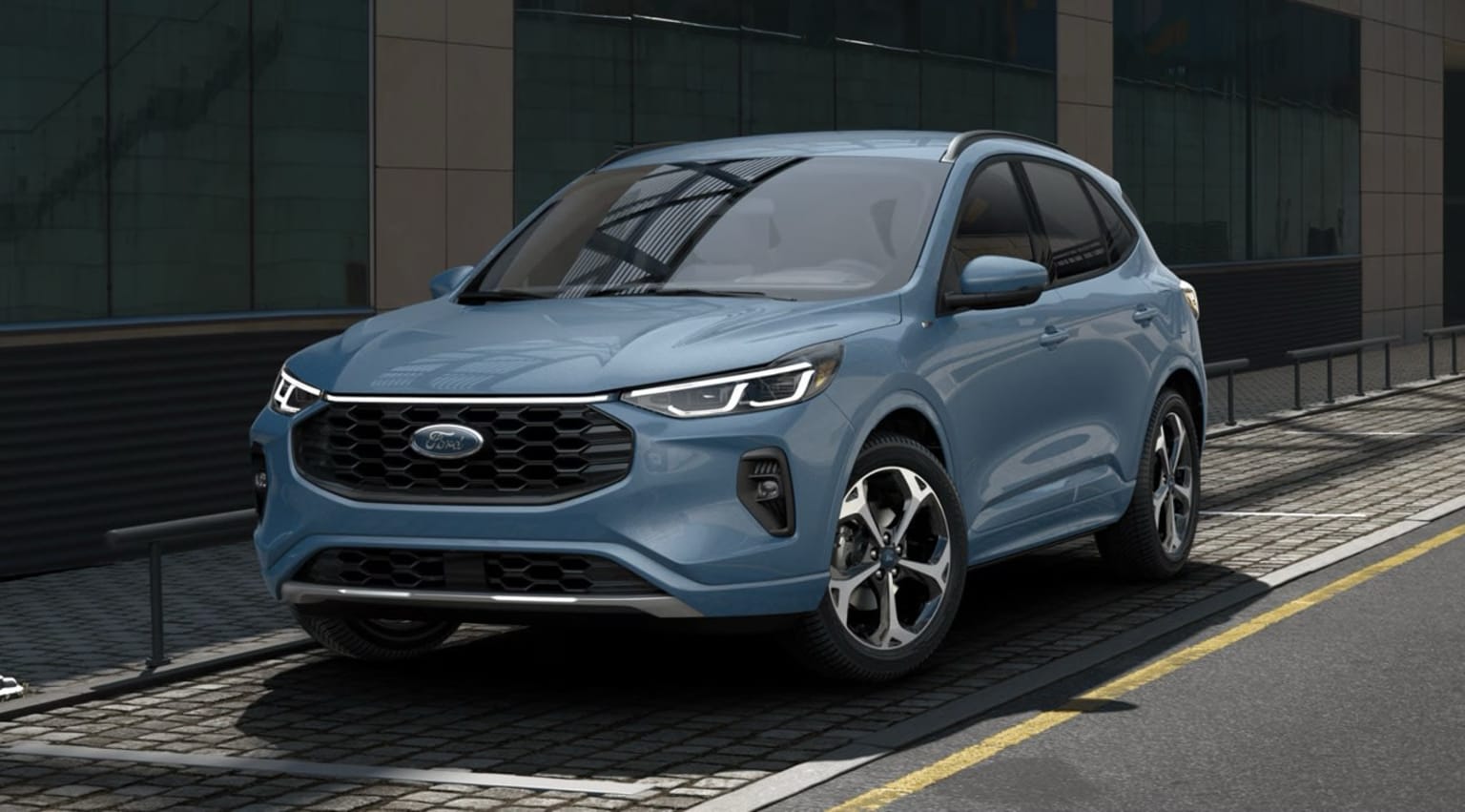 An SUV with a bold grille and distinctive headlights parked in front of a glass-fronted building, creating an urban and contemporary scene.